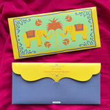 Persoanlized money envelope with a light green background with yellow elephants, a central orange palm tree, and orange floral motifs.
