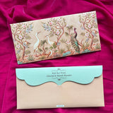 Persoanlized money envelope with a beige background and an ornate multicolor illustration of birds, flowers, and foliage, placed above a plain beige envelope with a light aqua scalloped flap.
